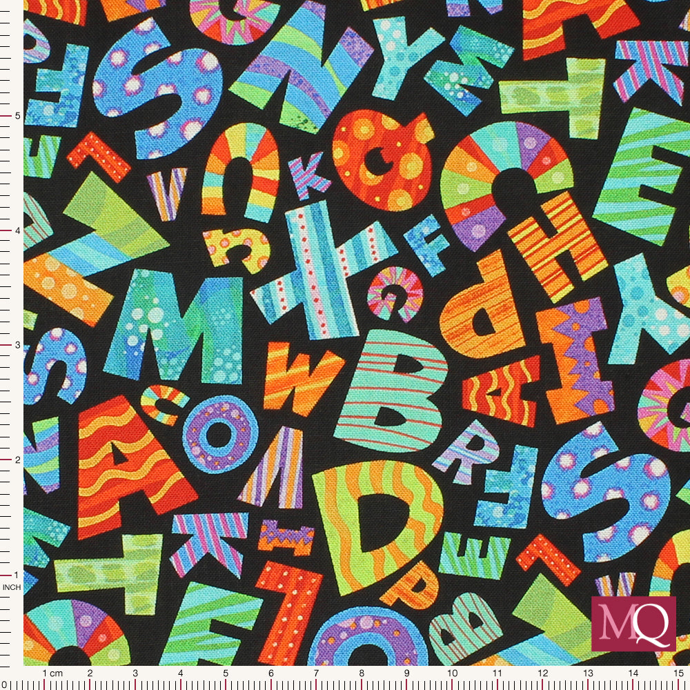 Cotton quilting fabric with jumbled rainbow patterned letters on black background