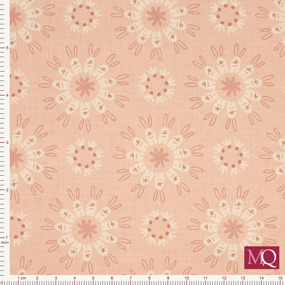 Cotton quilting fabric in muted warm pink with circles of rabbits in modern style