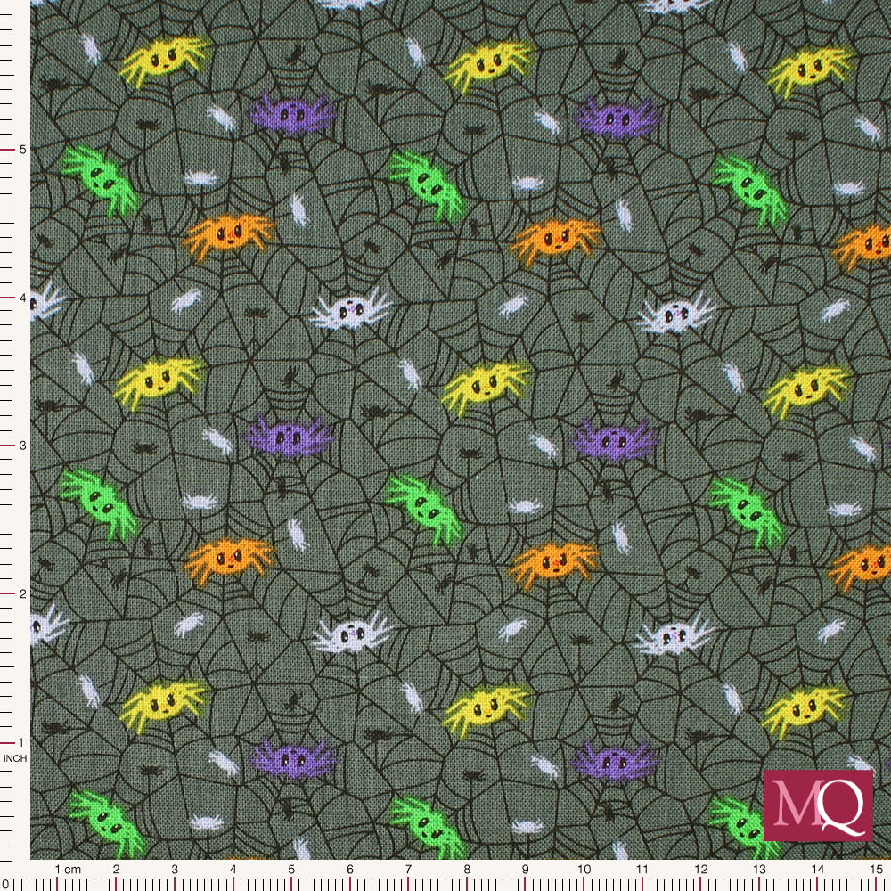 Cotton quilting fabric with novelty halloween print featuring cute spiders on cobweb background