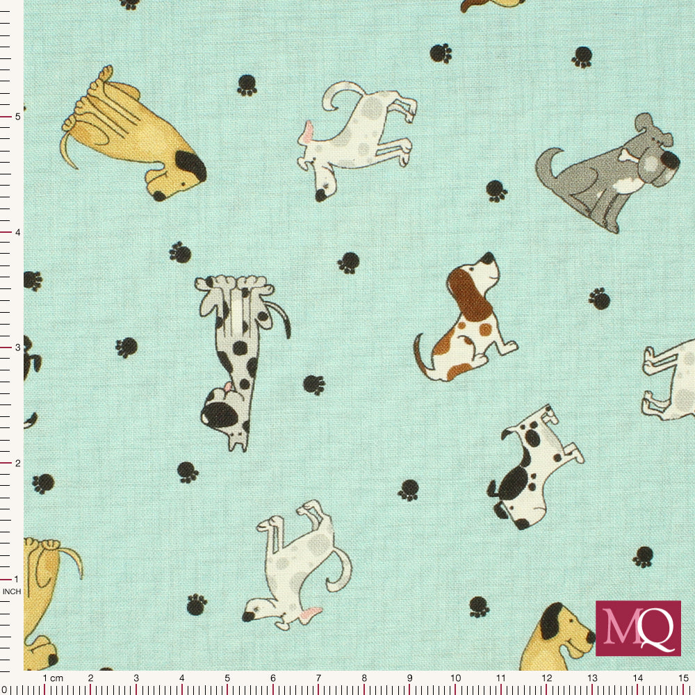 Cotton quilting fabric with novelty dog print all over on light blue