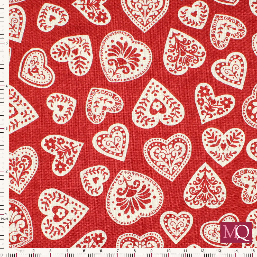 Cotton quilting fabric with folk style hearts tumbling on mottled red background