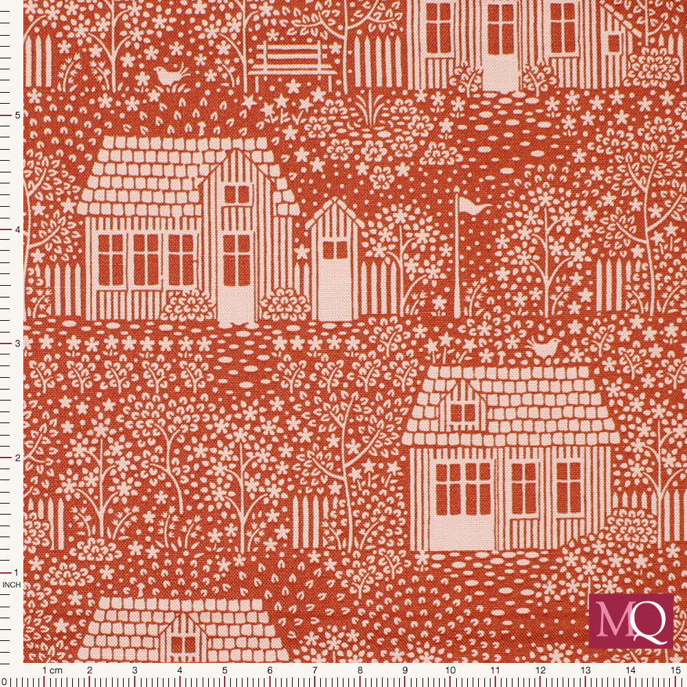Modern cotton quilting fabric with quaint white cottages printed on a red background