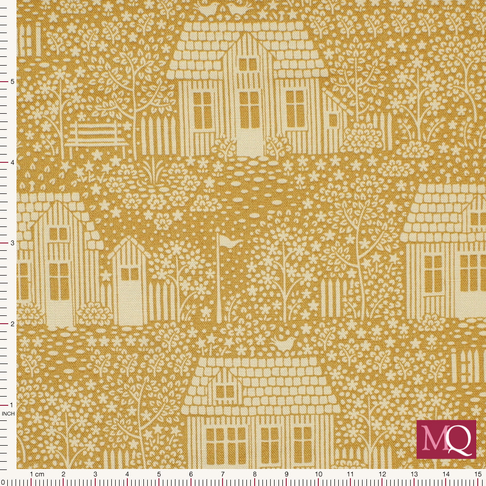 Cotton quilting fabric with white cottages printed on mustard yellow background