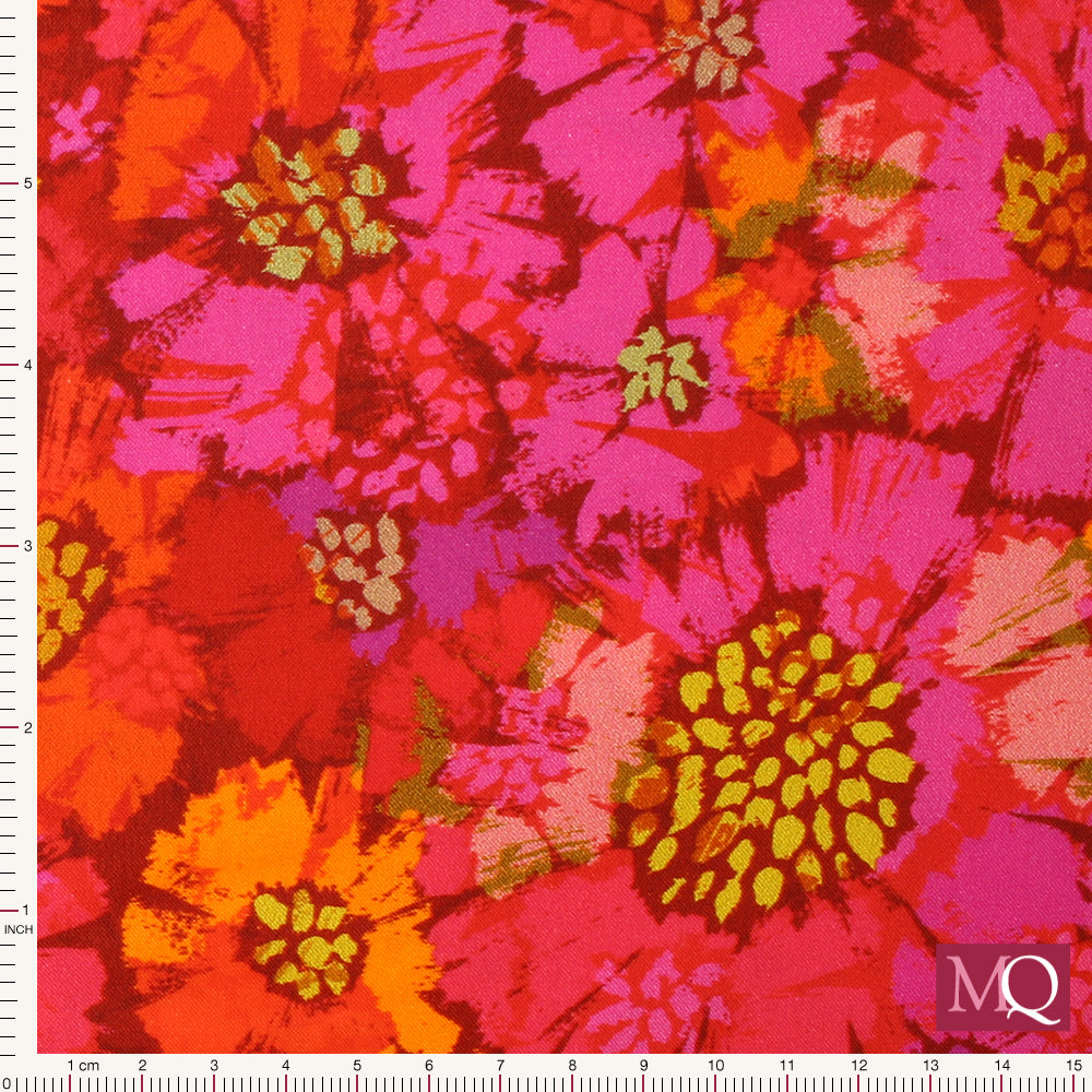 Cotton quilting fabric with bright painterly floral design in pinks, reds and oranges