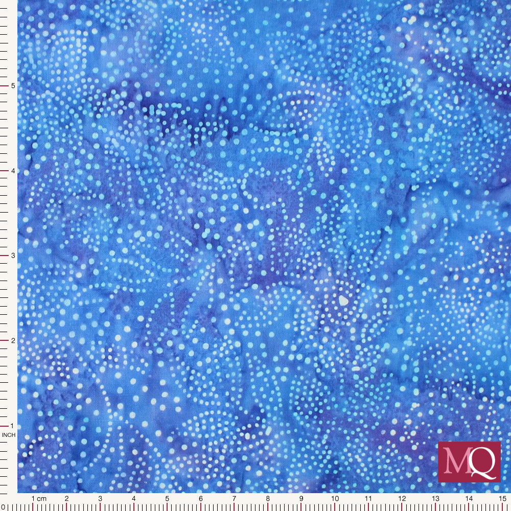 Cotton quilting fabric with dotted batik design featuring flowers and leaves on blue