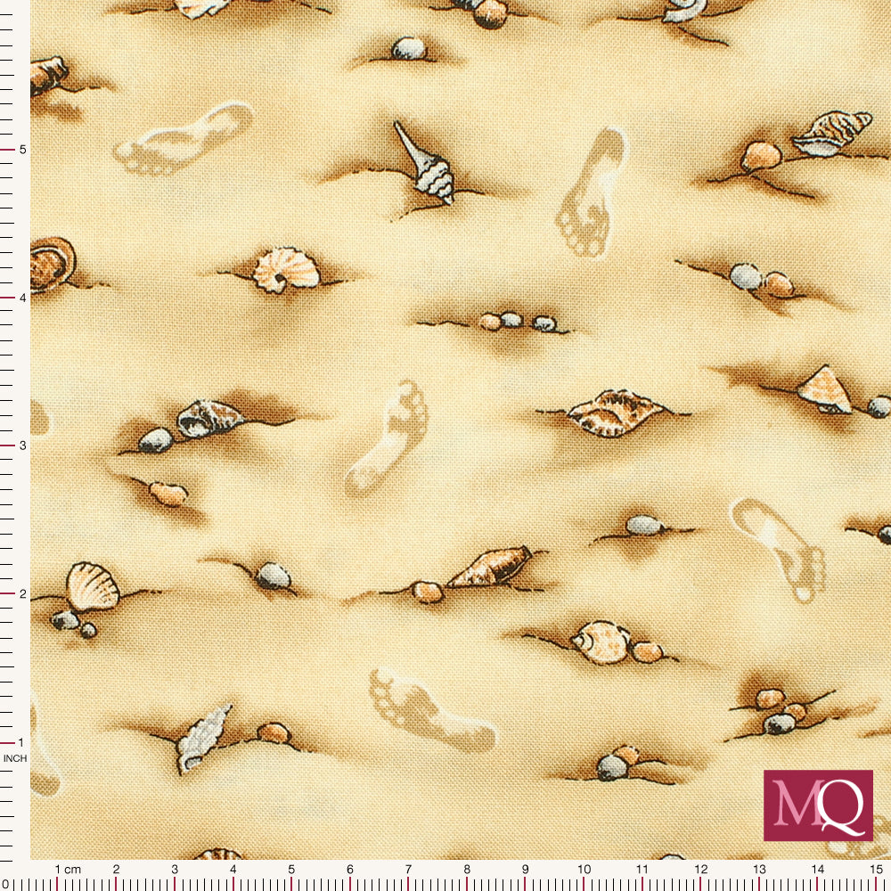 Cotton quilting fabric with sandy beach print featuring footprints and seashells