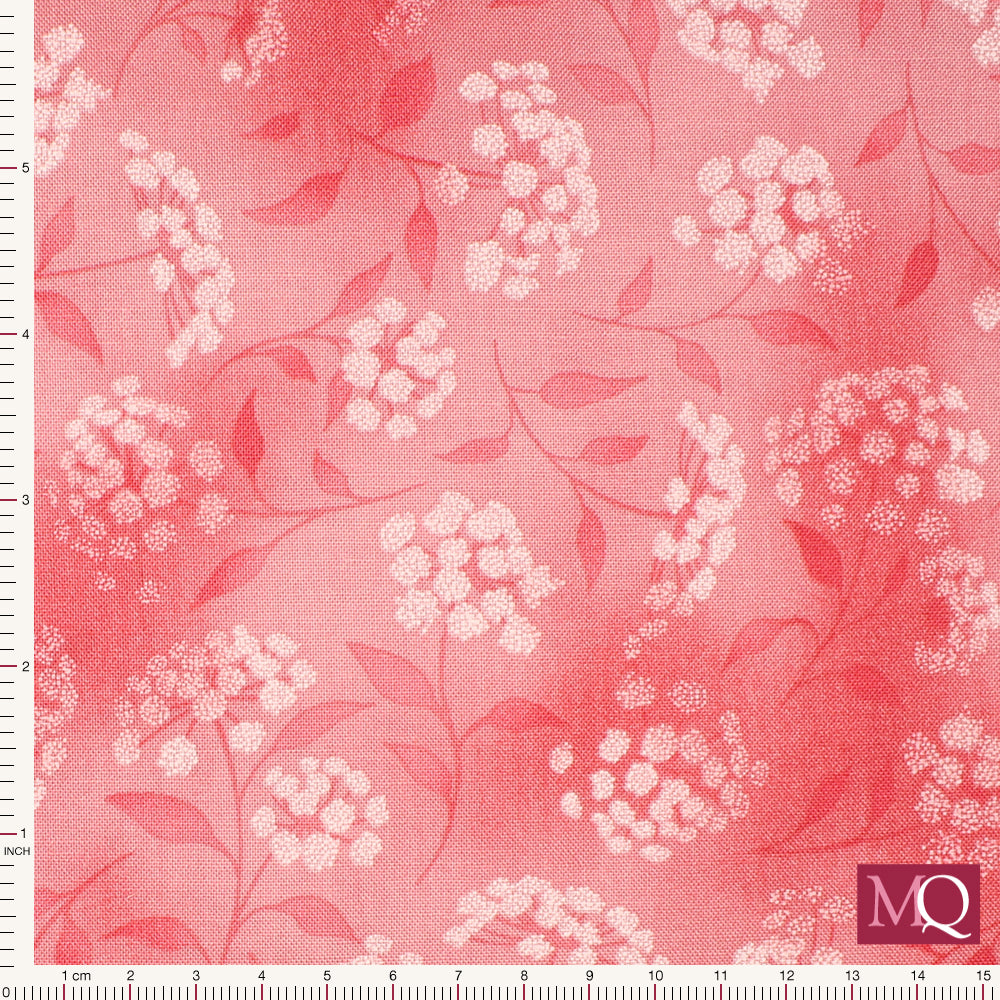 Cotton quilting fabric with pink floral camellia design on mottled pink background