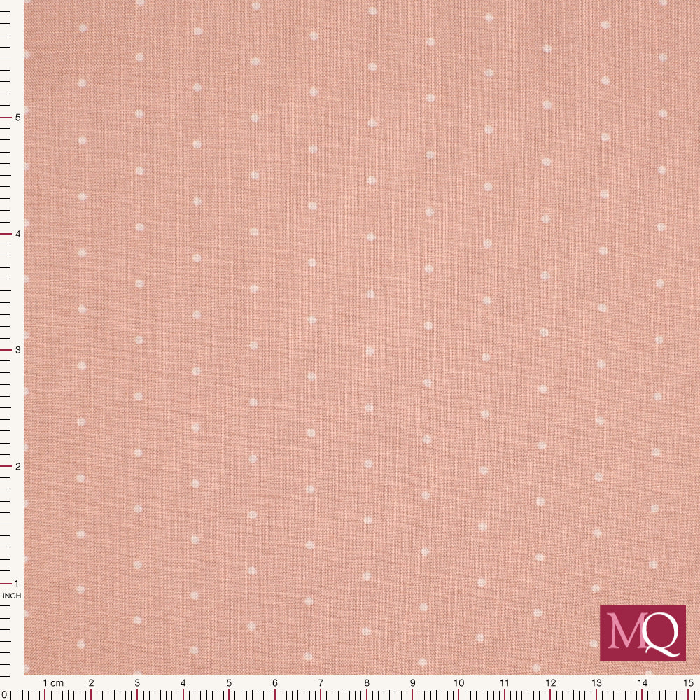 Cotton quilting fabric in muted pink with small tonal dots and a textured background