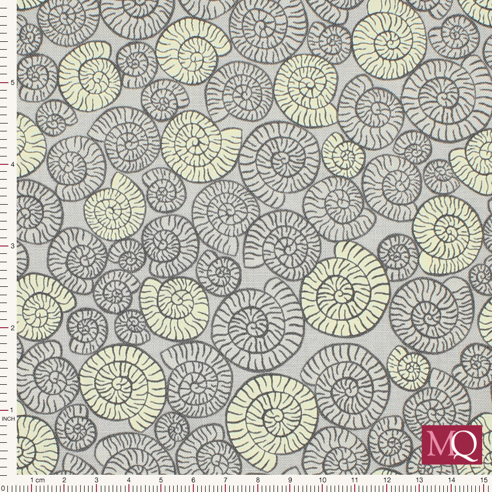 Cotton quilting fabric featuring grey ammonite fossils in a tonal grey design with glow in the dark highlights