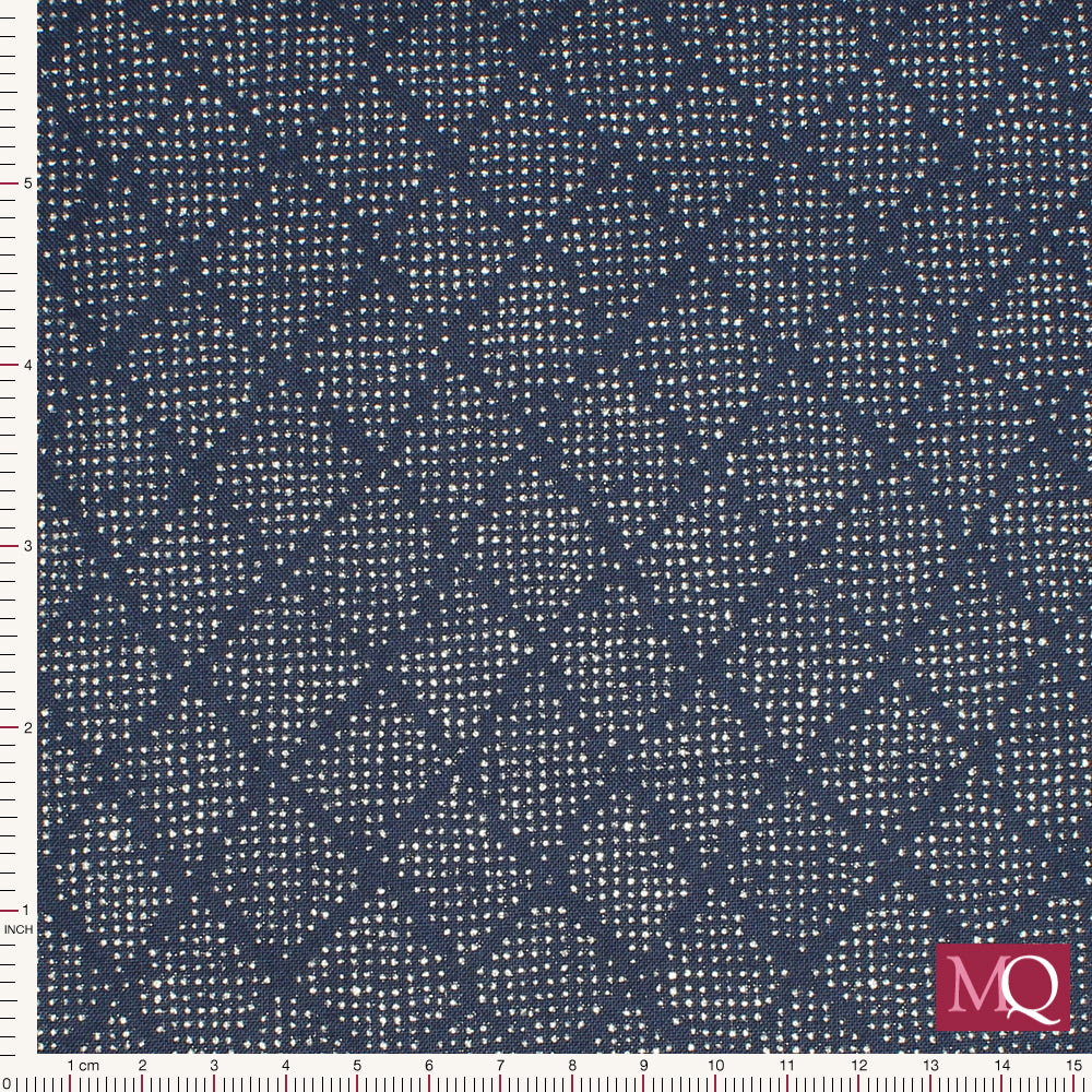 Cotton quilting fabric with tiny silver dots arranged in a loose pattern on navy background