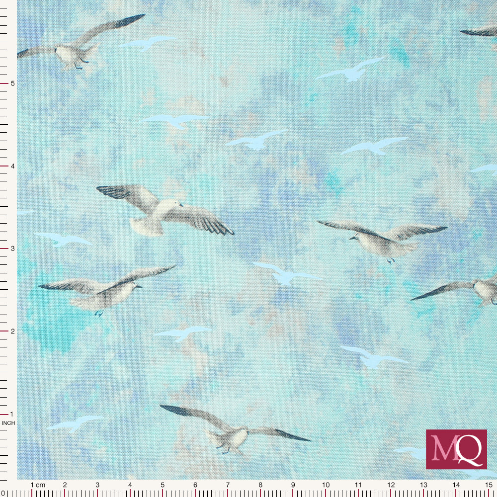 Cotton quilting fabric with soft flying seagulls on mottled blue background with light blue seagull silhouettes
