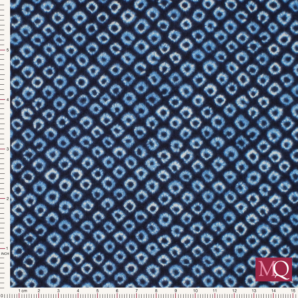 Cotton quilting fabric with shibori print in navy blue featuring small circles