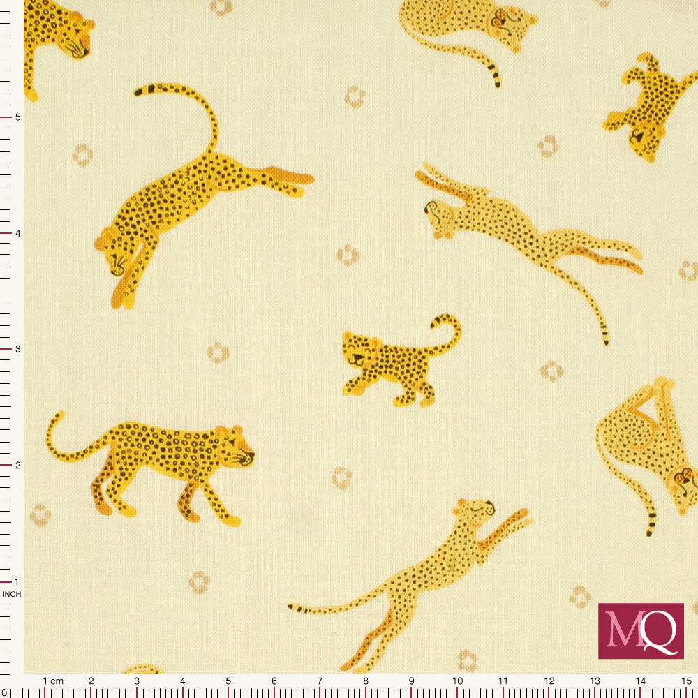 Cotton quilting fabric with smiling leopards and cheetahs on tonal light yellow background
