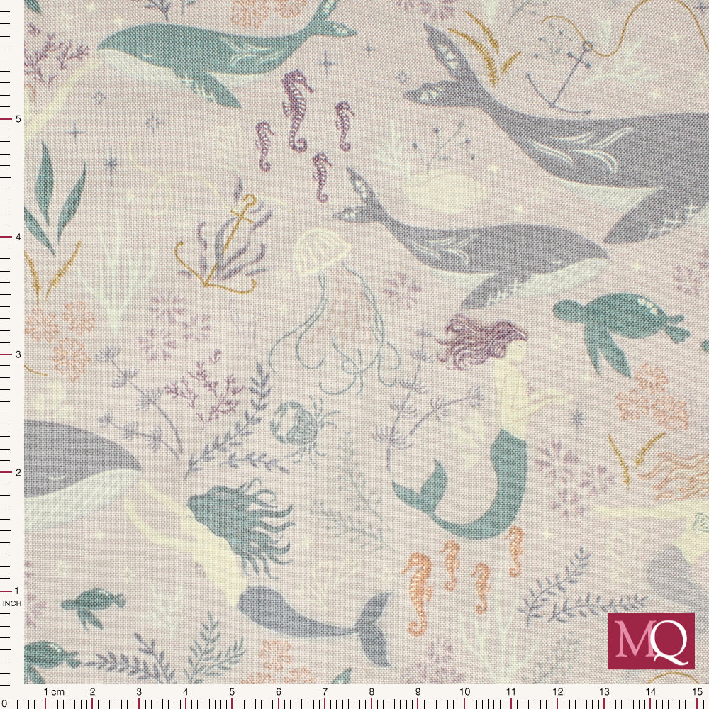 Cotton quilting fabric with modern under the sea print featuring whales, mermaids and turtles on warm lilac background
